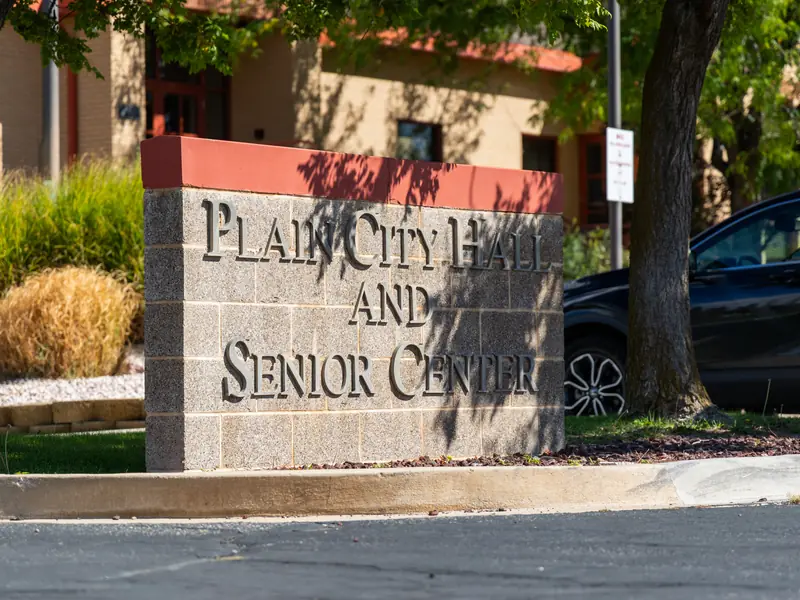 Plain City Hall and Senior Center sign under the trees