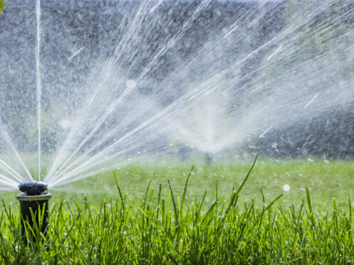 Sprinkler system watering the yard in Bountiful